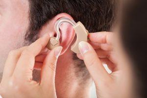 Person Adjusting Hearing Aid