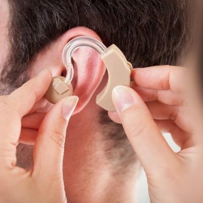 Person Adjusting Hearing Aid